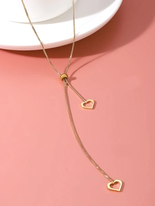 Detail of adjustable gold heart Y-necklace with sliding bead and openwork charms