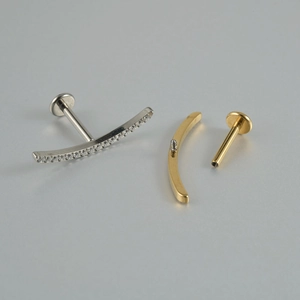 Macro shot of G23 titanium lip studs with zircon inlay and internal threading details