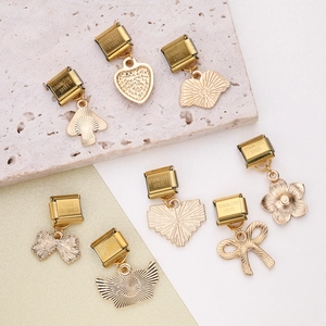 Set of 8 gold stainless steel charms with heart, flower, and bow shapes on stone base