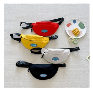 Close-up of four nylon kids chest bags in red, yellow, cream, and black colors