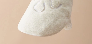 Close-up of soft white terry cloth fabric with high-density knit texture for face towels