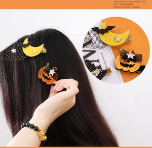Detail of Halloween hair clips with glitter pumpkin and black bat moon with tulle bows