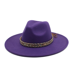 Detail of purple fedora hat featuring colorful woven band and stylish flat wide brim