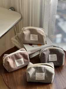 Detail showing colorful herringbone knit fabric textures and zip closure on storage pouches