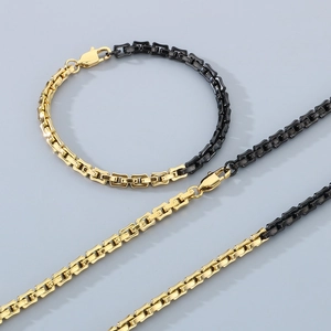 Minimalist black and gold stainless steel necklace and bracelet set with polished links