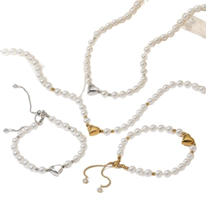 Elegant pearl jewelry set with heart pendants including necklaces and adjustable bracelets