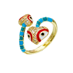 Detailed macro of a gold-plated snake ring with blue enamel and heart zircon eyes