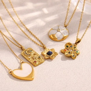 Detail of five 18K gold plated stainless steel necklaces with heart and flower charms