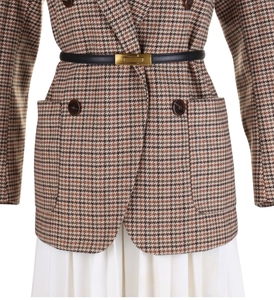 Detail of a brown houndstooth wool jacket with a slim black leather belt and gold buckle