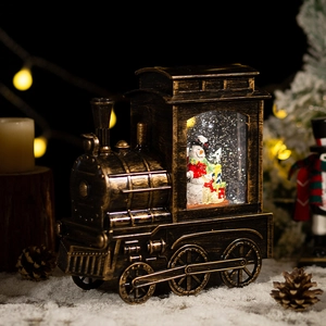 Vintage bronze Christmas train snow globe music box with snowman and festive warm lights