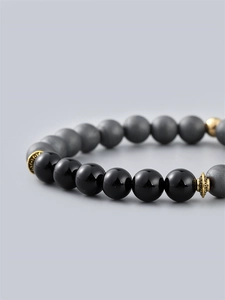 Men's beaded bracelet with black shiny and grey matte beads and vintage gold spacers
