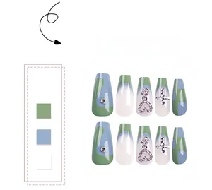 Macro detail of coffin press-on nails featuring cross charms and rhinestone heart pendants