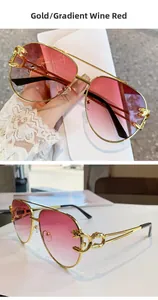 Detail of leopard sculpture on gold pilot sunglasses with burgundy gradient lenses