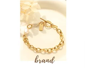 Detail showing OT toggle clasp and handmade tag on golden freshwater pearl bracelet
