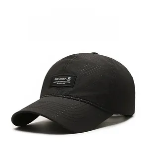 Detail view of black breathable mesh fabric and logo patch on quick-dry baseball cap