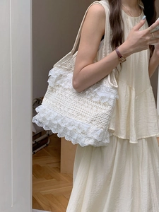Close-up of cream lace tote bag showing delicate mesh texture and shoulder drape