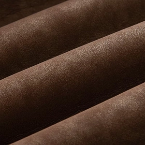Detailed macro view of dark brown faux leather fabric texture on a casual jacket