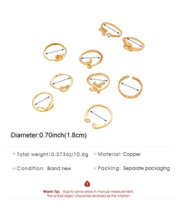 Detail view of 8-piece gold-plated copper rings featuring butterfly and feather motifs