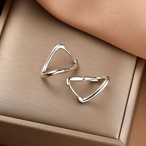 Boucles d'oreilles triangulaires en argent poli sur une boîte à bijoux dorée haut de gamme
