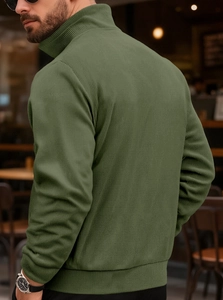 Detail of army green corduroy jacket with ribbed texture and stand-up collar shown from side