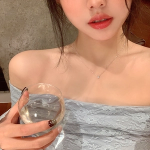 Minimalist S925 sterling silver single diamond necklace worn on collarbone with blue lace top
