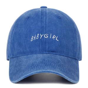 Détail de la broderie BABYGIRL blanche sur une casquette en jean bleu délavé vintage