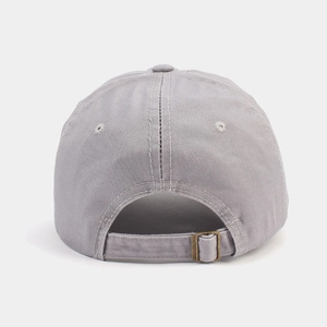 Detail of adjustable strap with vintage metal buckle on washed cotton golf baseball cap