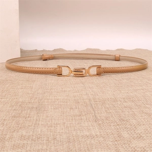 Detail of camel leather slim belt with gold metal hook buckle on textured fabric