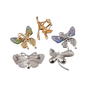 Five-piece set of butterfly and dancer pins in gold and silver finish on white background