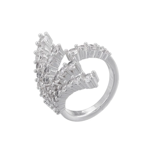 Macro shot of silver ring with tiered clear gemstones in a feather wing design
