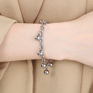 Elegant silver stainless steel beaded ball chain bracelet on female model's wrist
