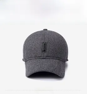 Detailed view of dark grey herringbone wool baseball cap with leather sport logo patch