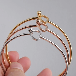 Detailed view of three-piece set minimalist open heart bangles in gold rose gold and silver