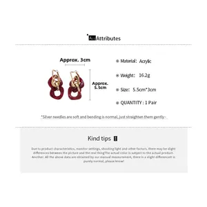 Detail view of red acrylic resin earrings with gold buckles and size specifications