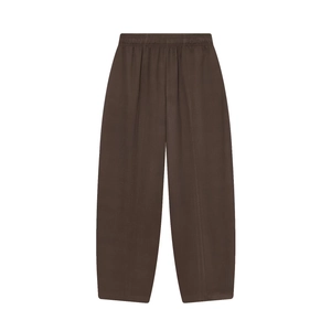 Detail of dark brown wide-leg trousers with elastic waistband and soft cotton fabric