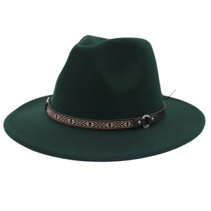 Detailed macro view of dark green wool fedora hat with ethnic patterned ribbon and leather band