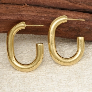 Detailed view of U-shaped gold earrings made of polished 304 stainless steel