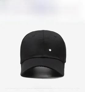 Detail of Peachy 3D embroidery on black cotton canvas baseball cap with white stitching