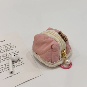Detailed macro view of pink heart quilted mini pouch storage case for wireless AirPods