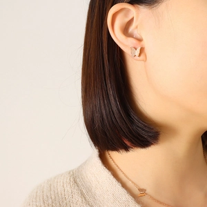 Close-up of rose gold butterfly jewelry set with matte finish on a female model