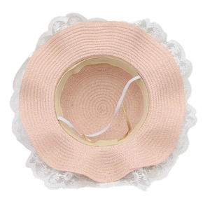 Detail view of pink straw hat for girls with white lace trim and elastic chin strap