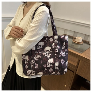 Detailed skull and floral print on canvas tote bag held by a model in casual setting