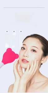 Detail showing dual-sided silicone facial brush with soft bristles and flat applicator