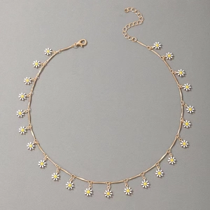 Detailed view of daisy choker with gold chain and white enamel flower charms
