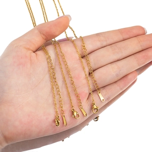 Gold stainless steel link chain necklace with lobster clasp and extender on palm