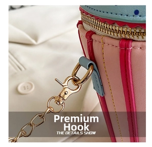 Detail shot of the golden metal hook and pink PU leather on the cylinder mini bag