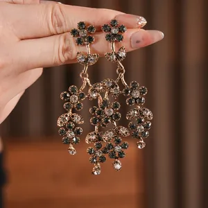 Vintage gold layered flower earrings with dark grey crystals and a luxury floral design