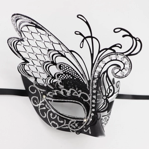 Detail of butterfly masquerade mask with silver glitter and rhinestones on black metal