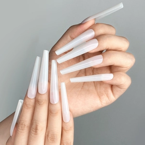Extra long C-curve milky white coffin nail tips shown on hands with sleek finish