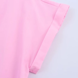 Detail shot of the pink poplin dress cuff showing fine fabric texture and stitching